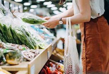 Mujer eligiendo hortalizas en supermercado clasificación alimentos